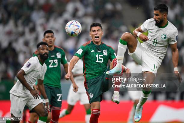 Saudi Arabia's midfielder Ali Al-Hassan and Saudi Arabia's forward Saleh Al-Shehri fight for the ball during the Qatar 2022 World Cup Group C...