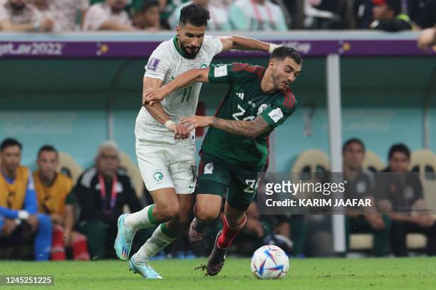 Saudi Arabia's forward Saleh Al-Shehri and Mexico's forward Henry Martin fight for the ball during the Qatar 2022 World Cup Group C football match...