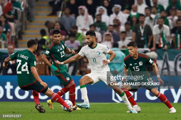 Saudi Arabia's forward Saleh Al-Shehri is challenged by Mexico's midfielder Luis Chavez, Mexico's defender Jesus Gallardo and Mexico's defender...
