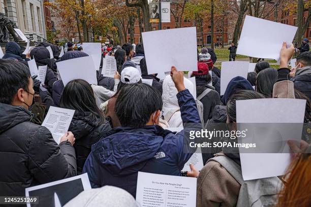 Protesters hold white pieces of paper during a demonstration against China's zero-covid policy and to commemorate victims of the Urumqi tragic fire...