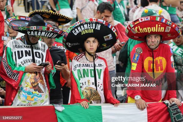 The sons of Mexico's 'super fan' Hector Ramirez, popularly known as "Caramelo", who are known as "Caramelo Jr" and a fan dressed as the Chapulín...
