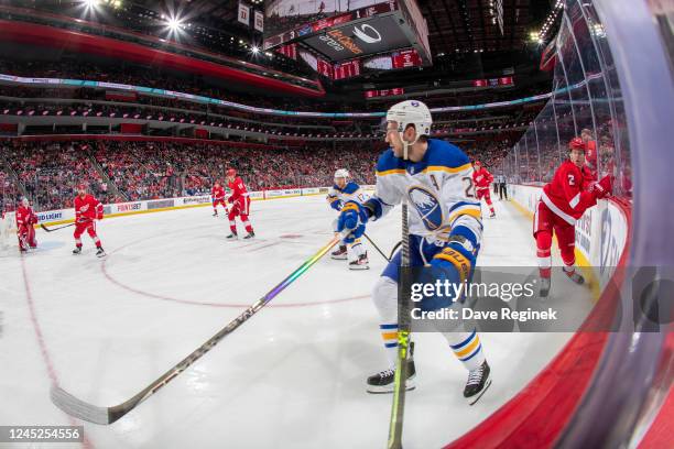 Zemgus Girgensons of the Buffalo Sabres skates after a loose puck in the corner with the stick of Olli Maatta of the Detroit Red Wings during the...