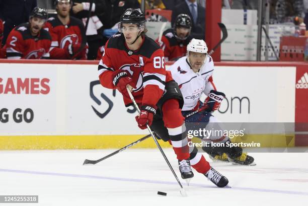 New Jersey Devils center Jack Hughes skates with the puck during the National Hockey League game between the Washington Capitals and the New Jersey...