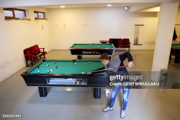 Youngsters play pool in a billards hall in the city of Has on November 14, 2022. - Albanians are now the largest single group making small-boat...