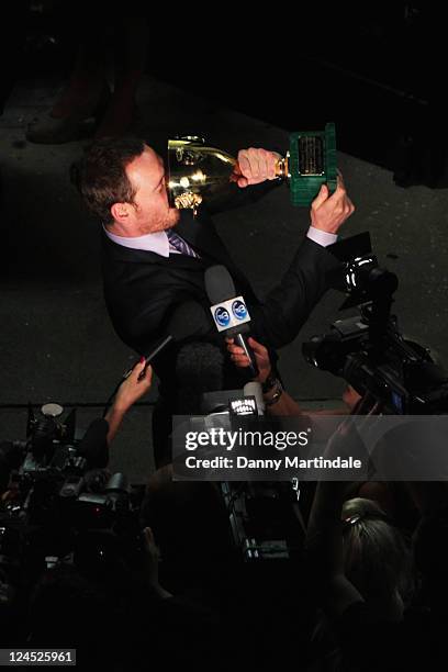 Actor Michael Fassbender of "Shame" walks with the Coppa Volpi for Best Actor he won during the Award Winners" Photocall during the 68th Venice...