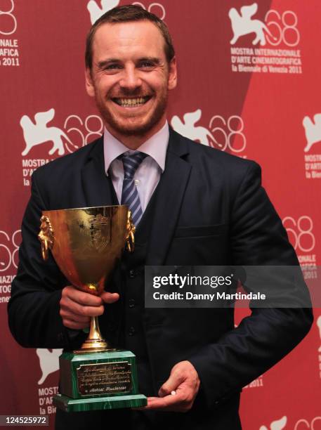 Actor Michael Fassbender of "Shame" poses with the Coppa Volpi for Best Actor during the Award Winners" Photocall during the 68th Venice...
