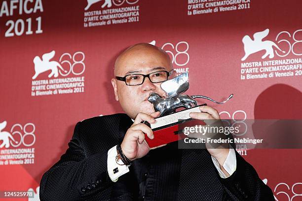 Director Shangjun Cai of "People Mountain People Sea" poses with the Silver Lion for Best Director during the Award Winners Photocall during the 68th...