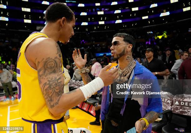 Puerto Rican rapper Anuel AA greets Juan Toscano-Anderson of the Los Angeles Lakers after the basketball game the Portland Trail Blazers at...