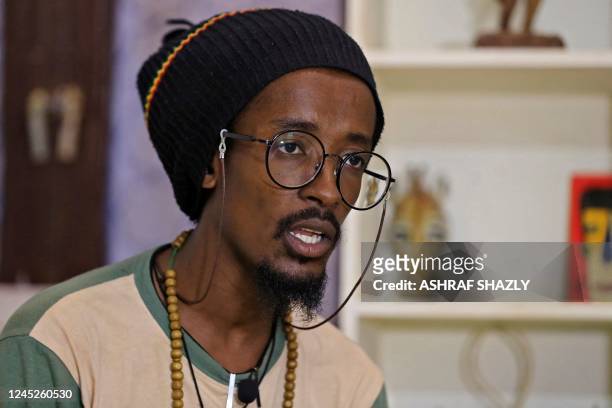Sudanese Rastafari Ahmed also know as Max Man, talk during an interview at an art exhibition in Sudan's capital Kahrtoum on October 14, 2022. - The...