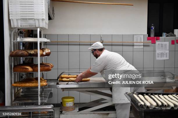 Baker prepares loaves of Baguette bread in a bakery in Brou near Chartres, southwest of Paris, on December 1, 2022.