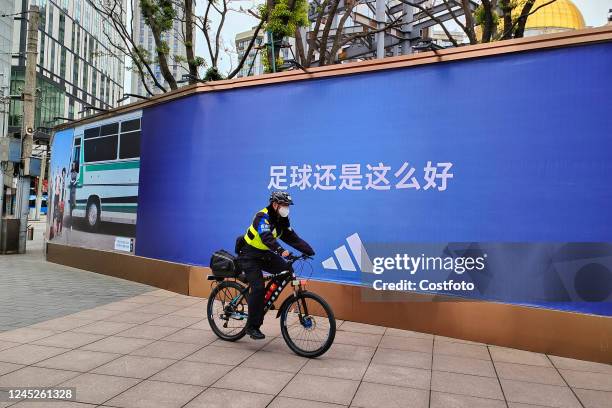 Slogan of Qatar World Cup sponsor ADIDAS promoting football is seen on Nanjing Road Pedestrian street in Shanghai, China, December 1, 2022.