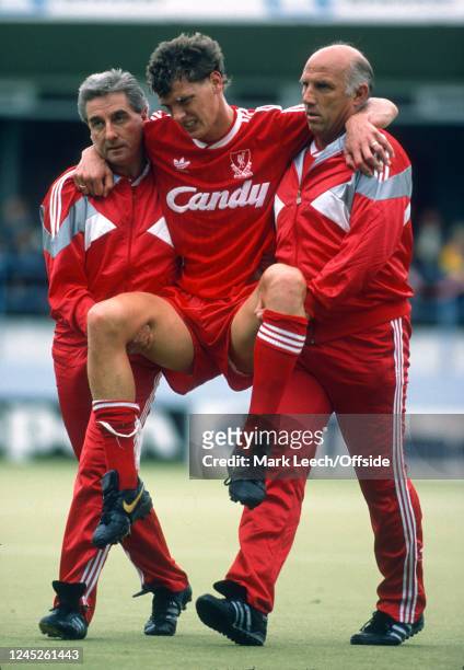 October 1988 Luton, Football League Division One - Luton Town v Liverpool - Roy Evans and Ronnie Moran carry Gary Gillespie of Liverpool off the...