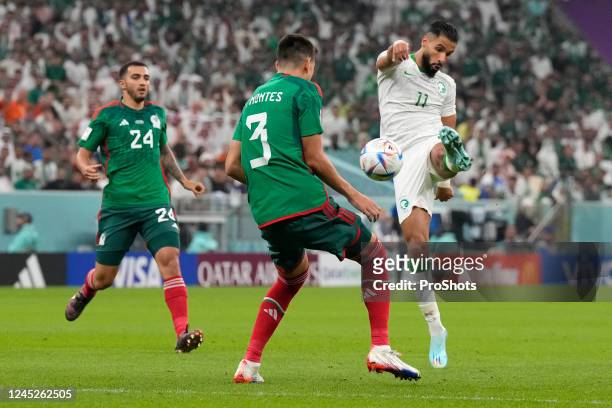 Lusail Stadium, World Cup 2022 in Qatar game between Saudi Arabia and Mexico, Mexico player Cesar Montes, Saudi Arabia player Saleh Alshehri - Photo...
