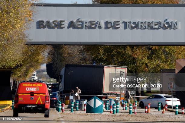 Ilitary police stand guard at the main entrance of the Spanish air force base, in Torrejon de Ardoz near Madrid, on December 1 after Spain's security...