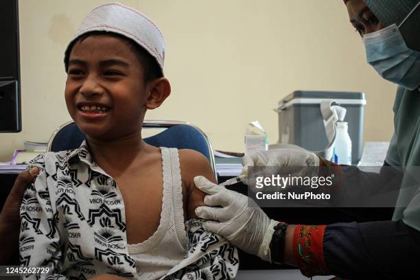Health workers inject students with the Diphtheria and Tetanus vaccines during child immunization at an elementary school in Lhokseumawe City, on...