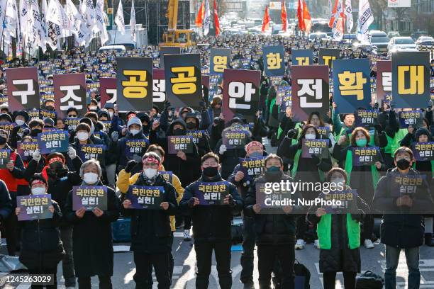 Members of the Korean Confederation of Trade Unions' Public Transport Workers' Union hold a joint strike-total-strength resolution rally near the...