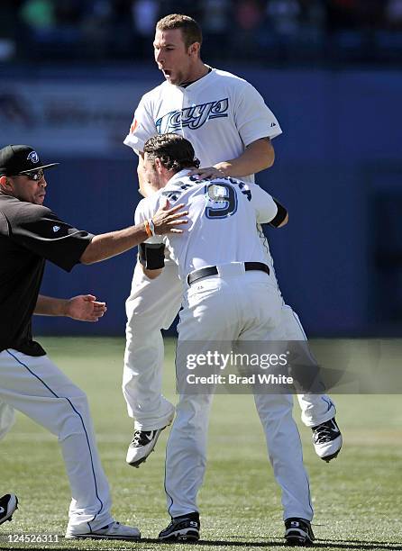 Brett Lawrie and J.P. Arencibia of the Toronto Blue Jays celebrate the teams win over the Baltimore Orioles during MLB game action September 10, 2011...