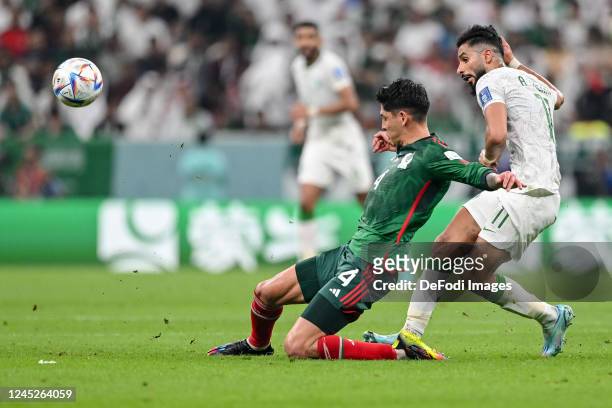 Edson Alvarez of Mexico and Saleh Al Shehri of Saudi Arabia battle for the ball during the FIFA World Cup Qatar 2022 Group C match between Saudi...