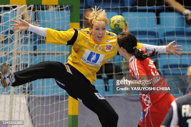Norway's goalkeeper Katrine Haraldsen spreads out to block a shot from Croatia's Maja Zebic during their Women's World Handball Championship...