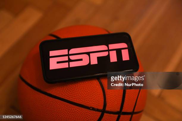 Logo displayed on a phone screen and a basketball are seen in this illustration photo taken in Krakow, Poland on December 1, 2022.
