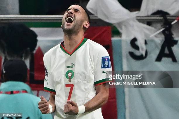 Morocco's midfielder Hakim Ziyech celebrates scoring his team's first goal during the Qatar 2022 World Cup Group F football match between Canada and...