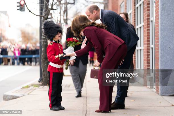 Britain's Prince William, Prince of Wales, and Catherine, Princess of Wales are presented with flowers by Henry Dynov-Teixeira, aged 8, dressed as a...