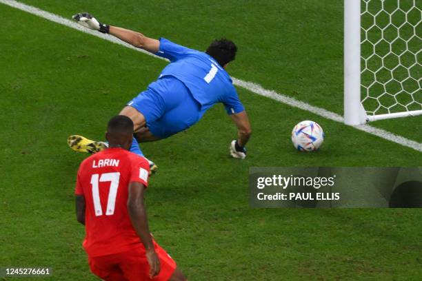 Morocco's goalkeeper Yassine Bounou concedes a shot by Morocco's defender Nayef Aguerd during the Qatar 2022 World Cup Group F football match between...