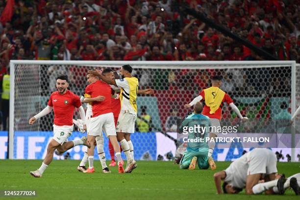 Canada's goalkeeper Milan Borjan reacts as Morocco's players celebrate winning the Qatar 2022 World Cup Group F football match between Canada and...