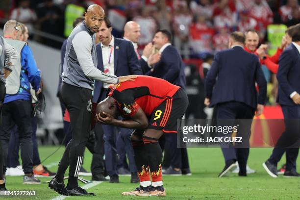 Belgium's French assistant coach Thierry Henry cobsoles Belgium's forward Romelu Lukaku after the Qatar 2022 World Cup Group F football match between...