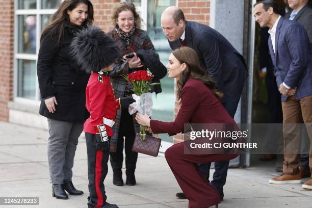 Prince William, Prince of Wales and Catherine, Princess of Wales receive flowers from Henry Dynov-Teixeira as they depart Greentown Labs, which bills...