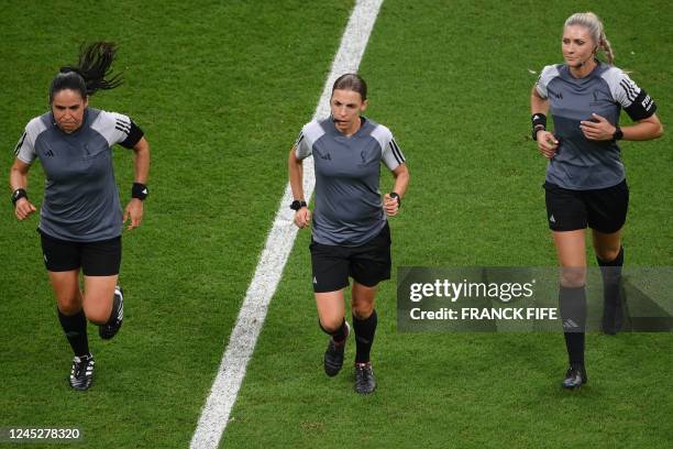 French referee Stephanie Frappart , Mexican assistant referee Karen Diaz and Brazilian assistant referee Neuza Back warm up before the Qatar 2022...