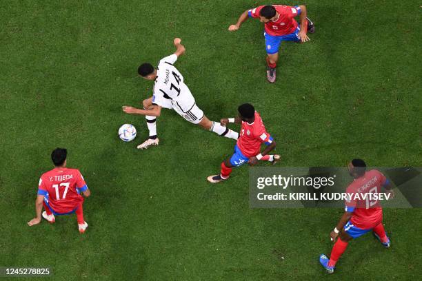 Germany's midfielder Jamal Musiala fights for the ball with Costa Rica's midfielder Yeltsin Tejeda , Costa Rica's defender Keysher Fuller , Costa...