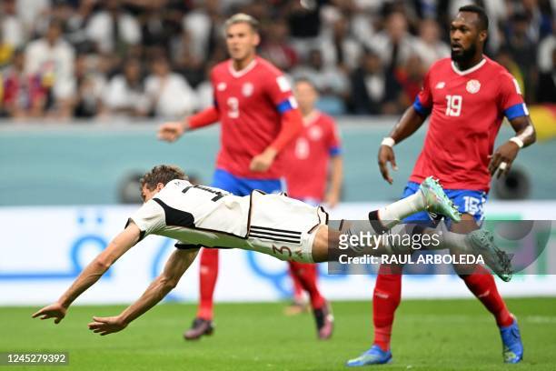 Germany's forward Thomas Mueller dives for the ball past Costa Rica's defender Kendall Waston during the Qatar 2022 World Cup Group E football match...