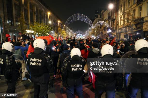 Moroccans living in Brussels celebrate after Morocco advanced to the last 16 of the World Cup following the FIFA World Cup Qatar Group F match...