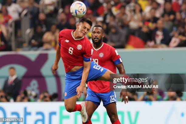 Costa Rica's defender Oscar Duarte heads the ball next to Costa Rica's defender Kendall Waston during the Qatar 2022 World Cup Group E football match...