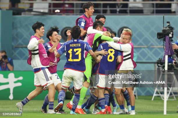Ritsu Doan of Japan celebrates with his team mates after scoring a goal to make it 1-1 during the FIFA World Cup Qatar 2022 Group E match between...