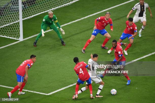 Germany's midfielder Jamal Musiala fights for the ball with Costa Rica's defender Keysher Fuller and Costa Rica's defender Kendall Waston during the...