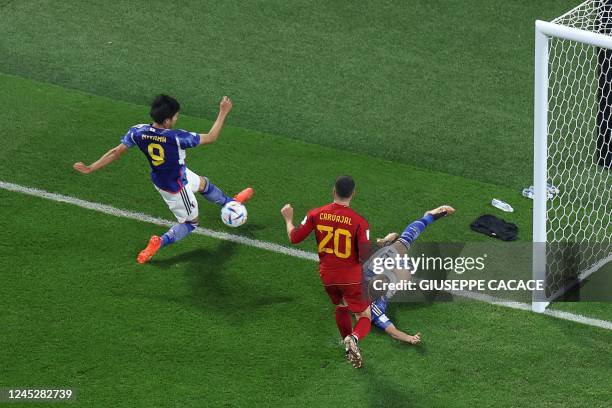 Japan's forward Kaoru Mitoma crosses the ball for his team's second goal during the Qatar 2022 World Cup Group E football match between Japan and...