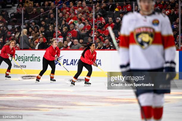 Calgary Flames ice girls clear the ice during the first period of an NHL game between the Calgary Flames and the Florida Panthers on November 29 at...