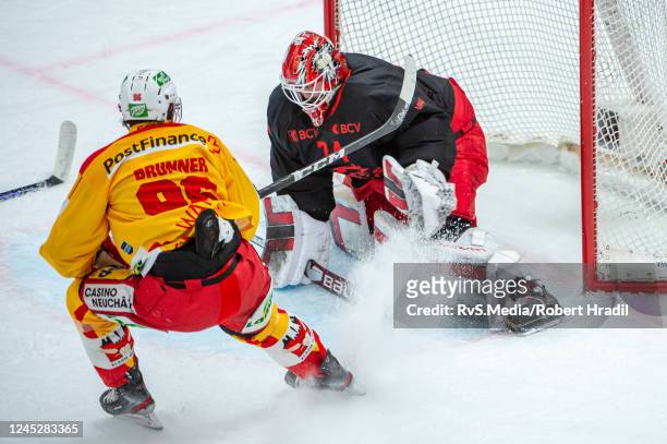 Damien Brunner of EHC Biel tries to score against Goalie Ivars Punnenovs of Lausanne HC during the Swiss National League game between Lausanne HC and...