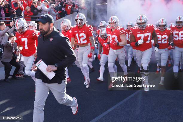 Ohio State Buckeyes players run onto the field behind head coach Ryan Day prior to a college football game against the Michigan Wolverines on...