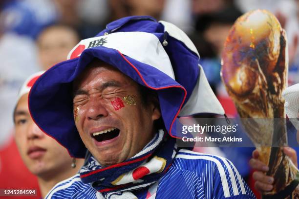 Japan fan sheds tears of joy alongside a replica world cup trophy during the FIFA World Cup Qatar 2022 Group E match between Japan and Spain at...