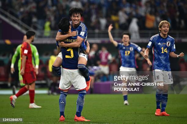 Japan's players react after the Qatar 2022 World Cup Group E football match between Japan and Spain at the Khalifa International Stadium in Doha on...