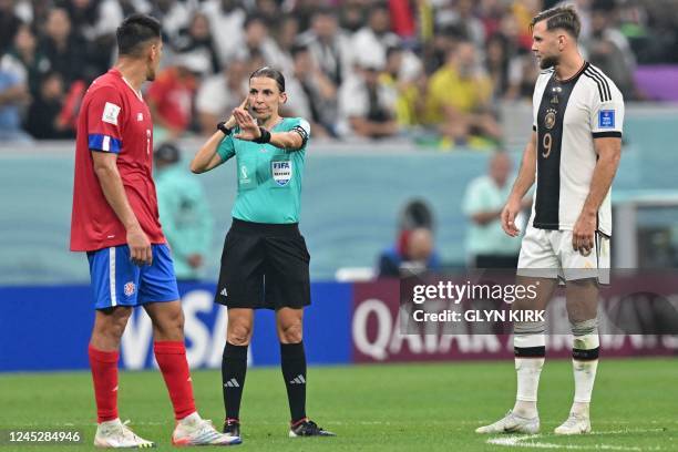 Germany's forward Niclas Fuellkrug waits for French referee Stephanie Frappart's decision after he scored his team's fourth goal during the Qatar...