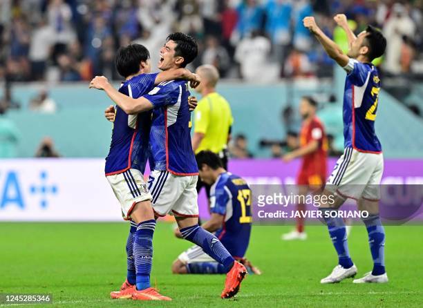 Japan's teammates celebrate after winning the Qatar 2022 World Cup Group E football match between Japan and Spain at the Khalifa International...