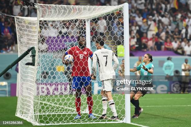 French referee Stephanie Frappart intervenes as Germany's midfielder Kai Havertz tries to take the ball from Costa Rica's defender Kendall Waston...