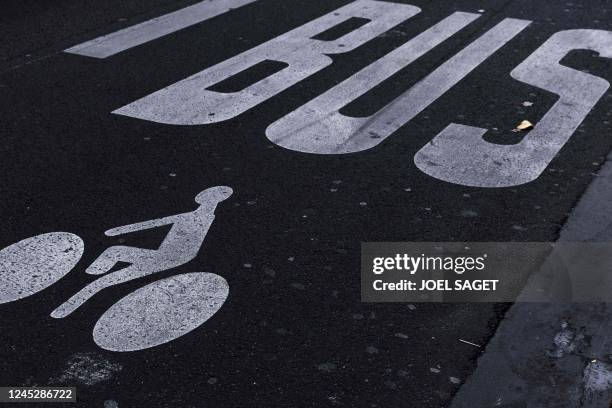 This photograph taken in Paris on December 1, 2022 shows a road sign marking a cycling and bus lane.