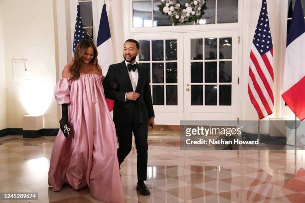 John Legend and Chrissy Teigen arrive for the White House state dinner for French President Emmanuel Macron at the White House on December 1, 2022 in...