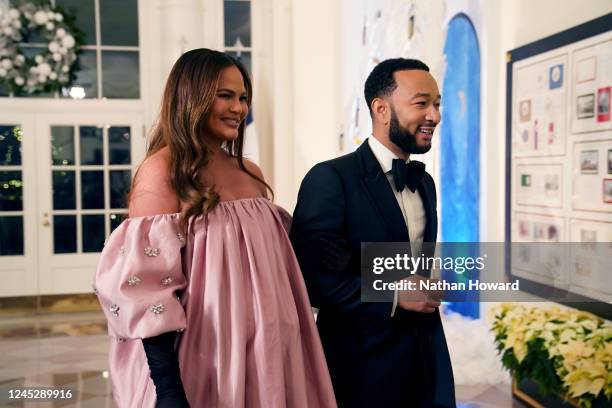 John Legend and Chrissy Teigen arrive for the White House state dinner for French President Emmanuel Macron at the White House on December 1, 2022 in...