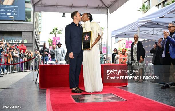 Actor Billy Porter and husband Adam Smith kiss on Porter's newly unveiled Hollywood Walk of Fame star in Hollywood, California, on December 1, 2022.